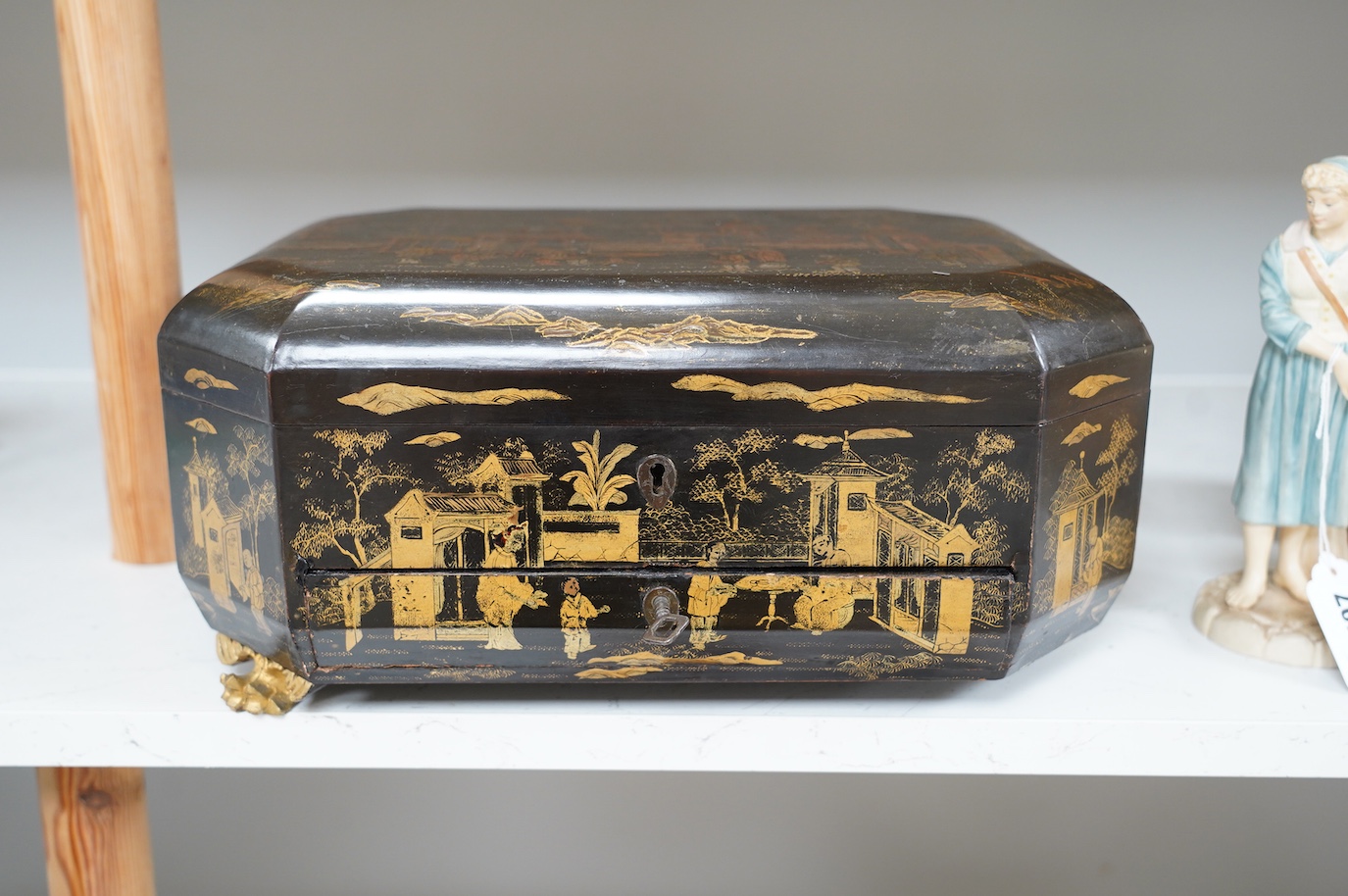 A Chinese black lacquer with gold decoration workbox, 36cm wide. Condition - one carved gilt paw foot missing to base